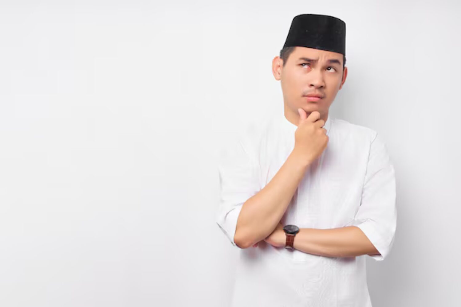 portrait-pensive-young-asian-muslim-man-looking-empty-space-touching-his-chin-thinking-about-offer-isolated-white-background-people-religious-islamic-lifestyle-concept_509243-8329